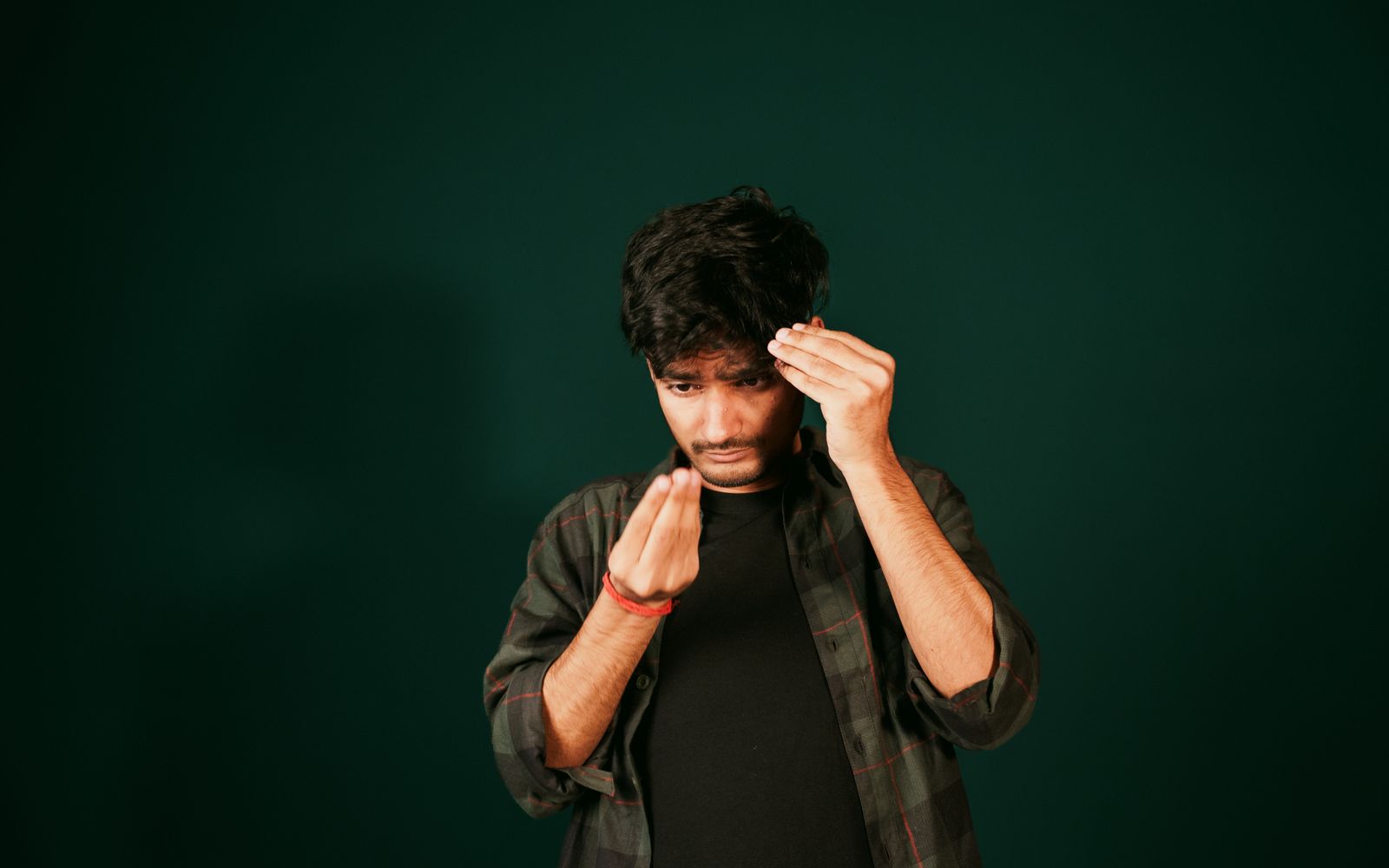 A man checking his hairline