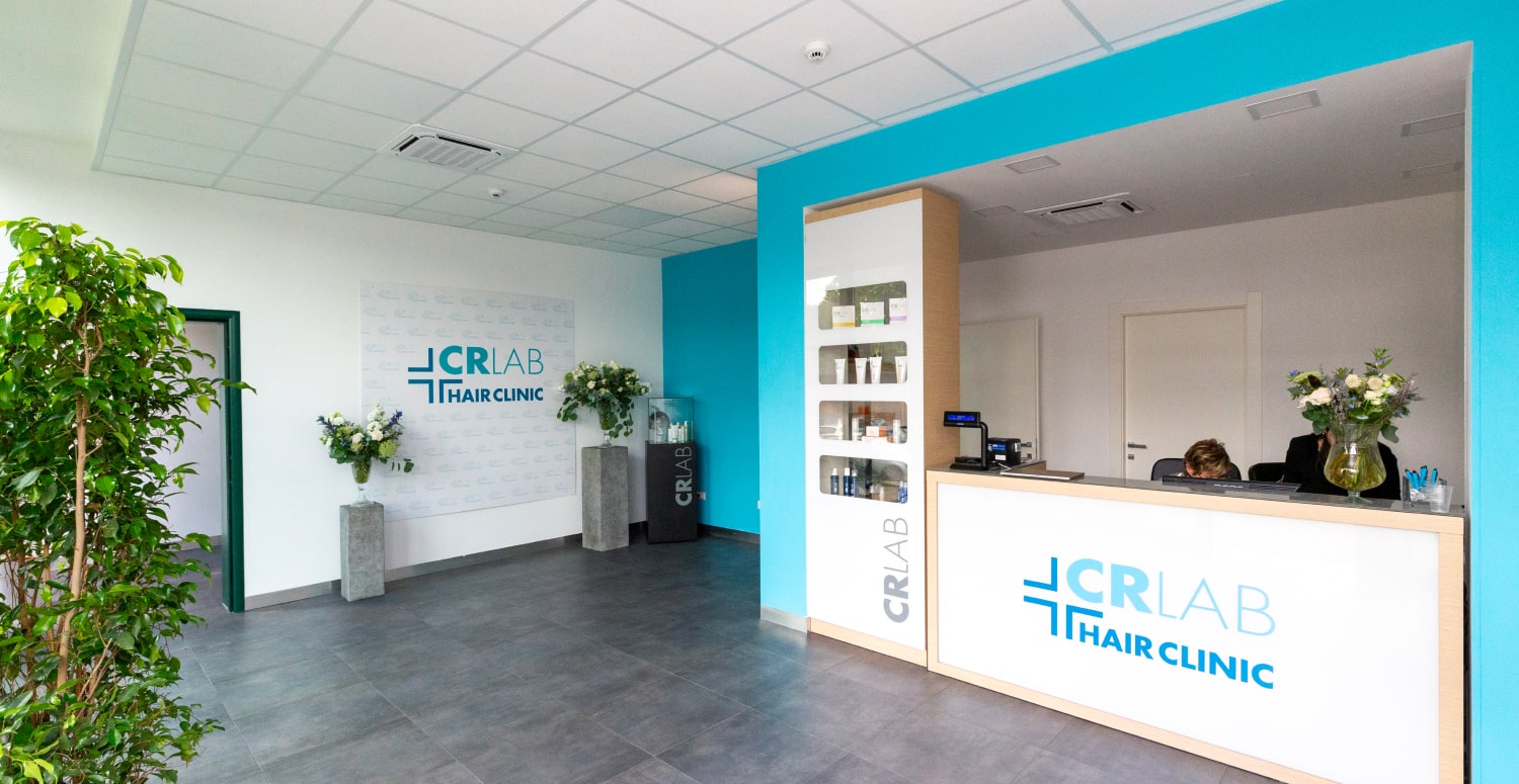 Reception of the CRLAB Hair Clinic, with the CRLAB Hair Clinic logo on the desk and wall