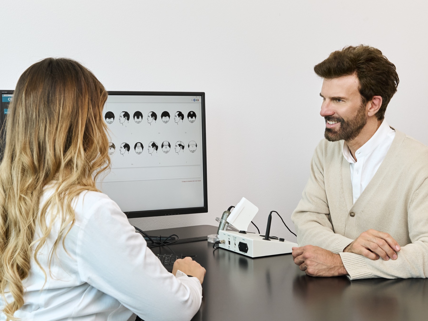 A CRLAB specialist reviewing TricoTest® images on screen with a client