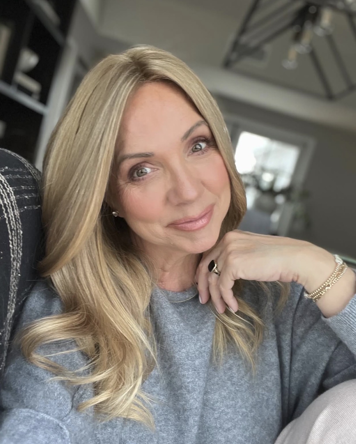Michele, smiling, with long, natural-looking blonde hair