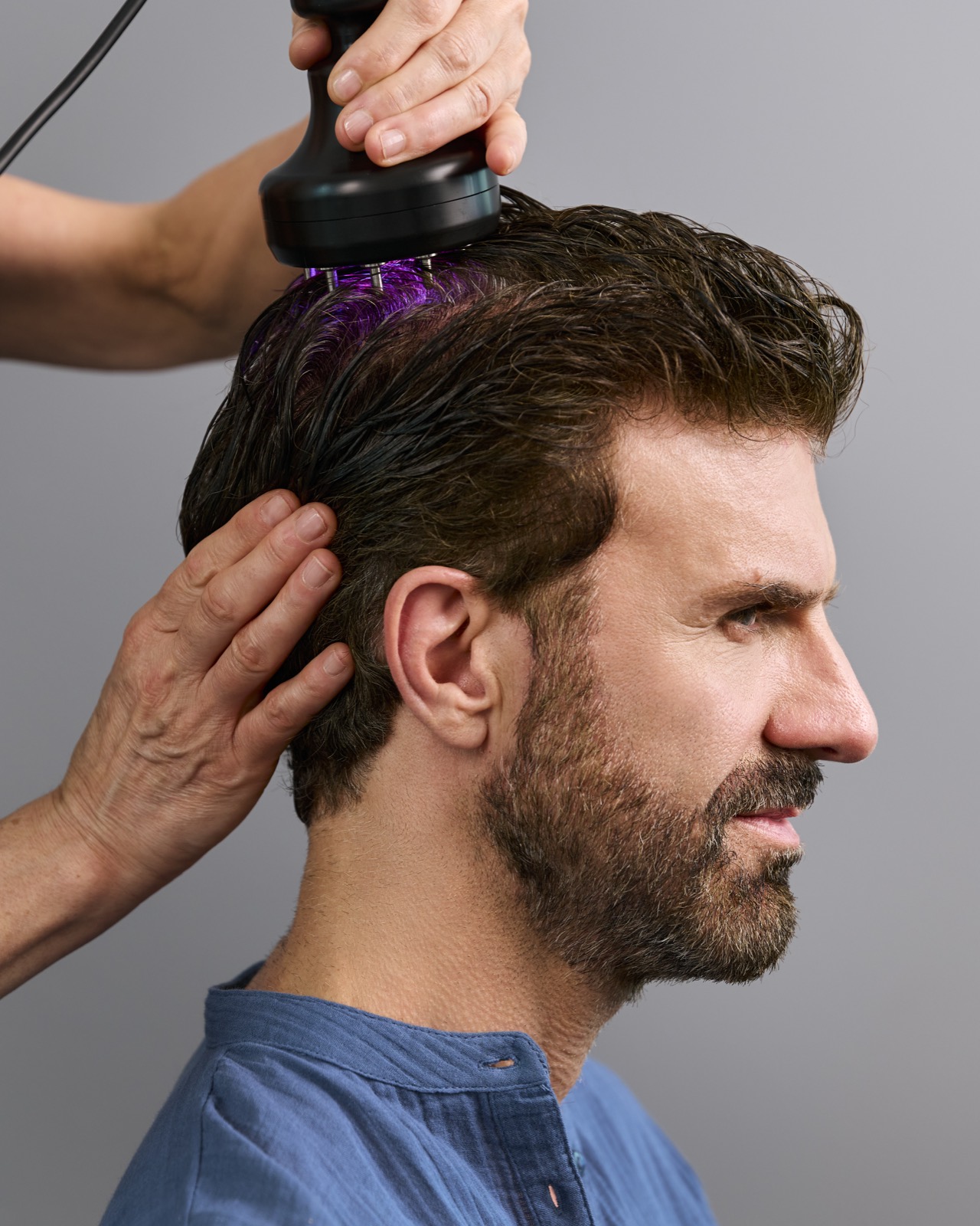 A specialist performing an in-studio scalp treatment